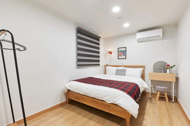 Bedroom4: a queen bed, a dressing table, clothes hanger