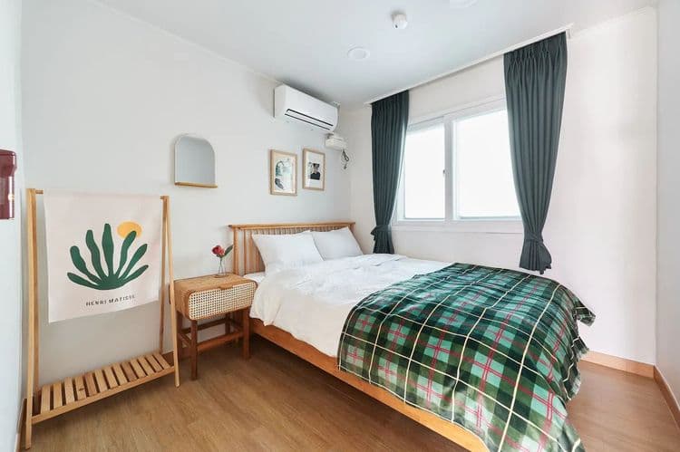 Bedroom3: a queen bed, a side table, clothes hanger