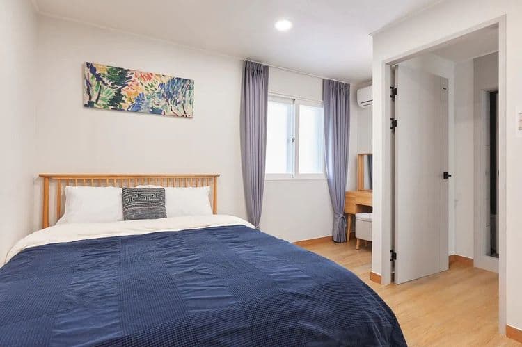 Bedroom2: a queen bed, a dressing table, clothes hanger